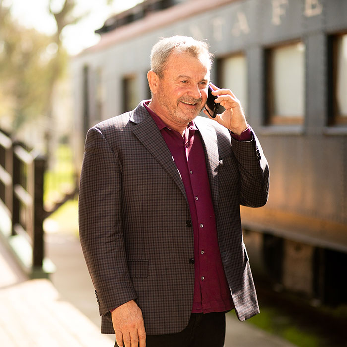 Tony talking on the phone at the train station photo